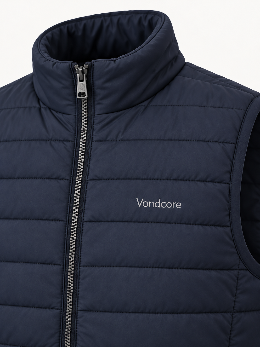 Detail of the navy Vondcore Ridge Quilted Vest showing collar, quilting, zipper and embroidered Vondcore logo.