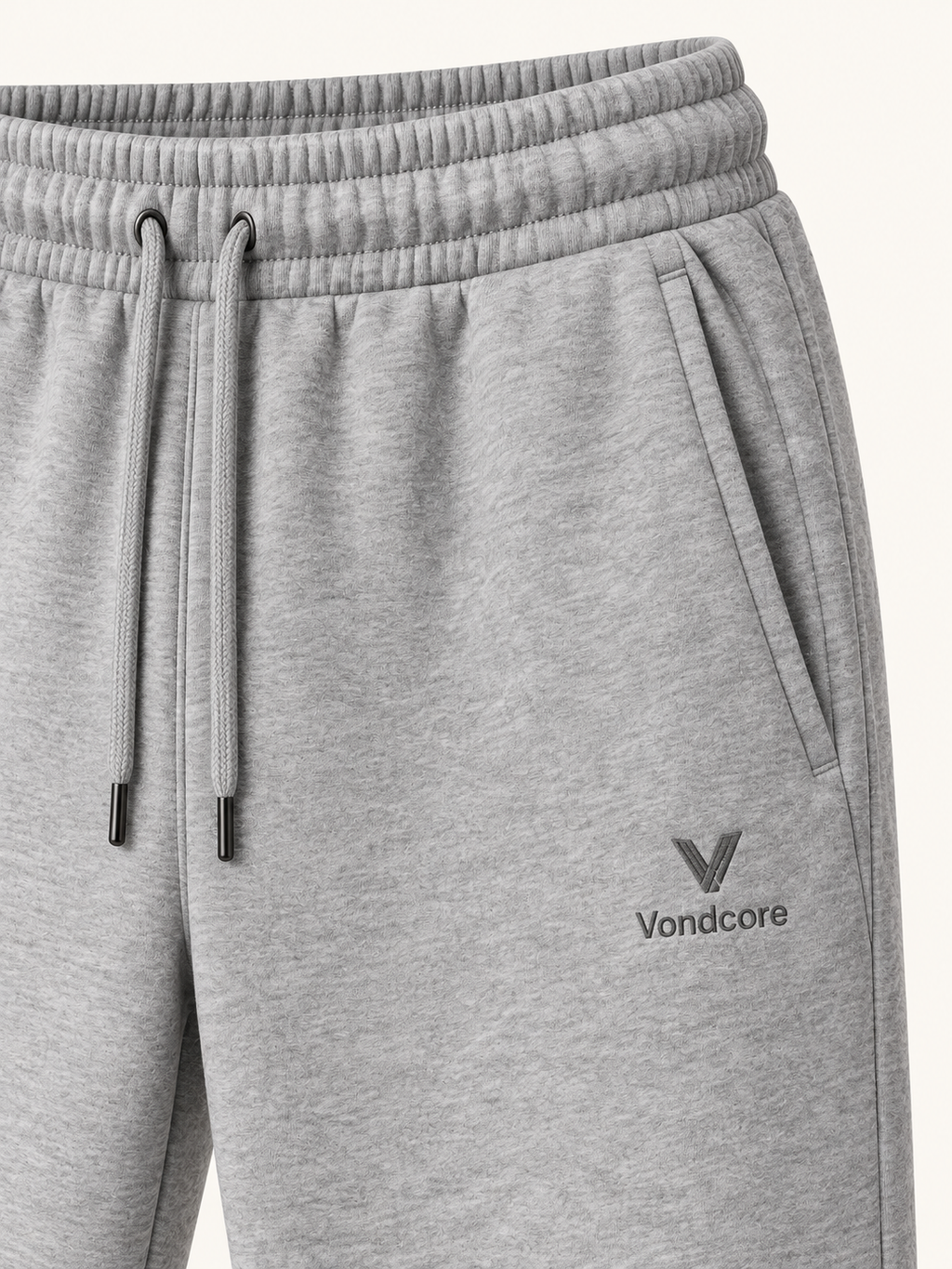 Detail of the heather gray Vondcore Haven Winter Joggers showing drawstring waist, side pocket and embroidered Vondcore logo.