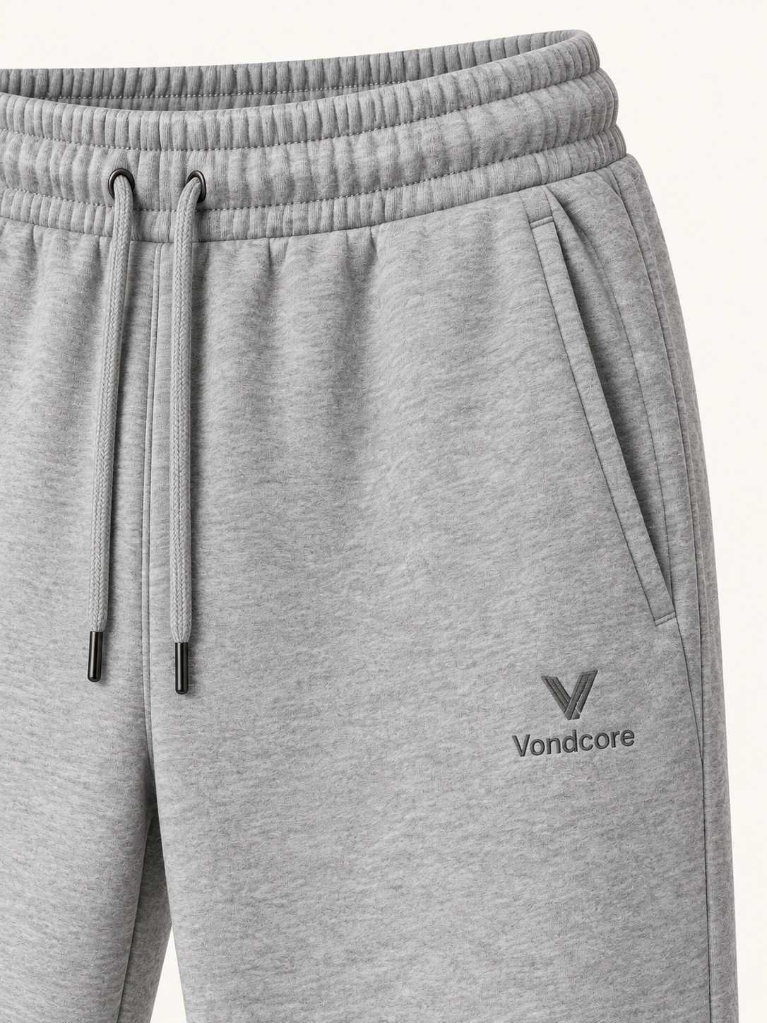 Detail of the heather gray Vondcore Haven Winter Joggers showing drawstring waist, side pocket and embroidered Vondcore logo.