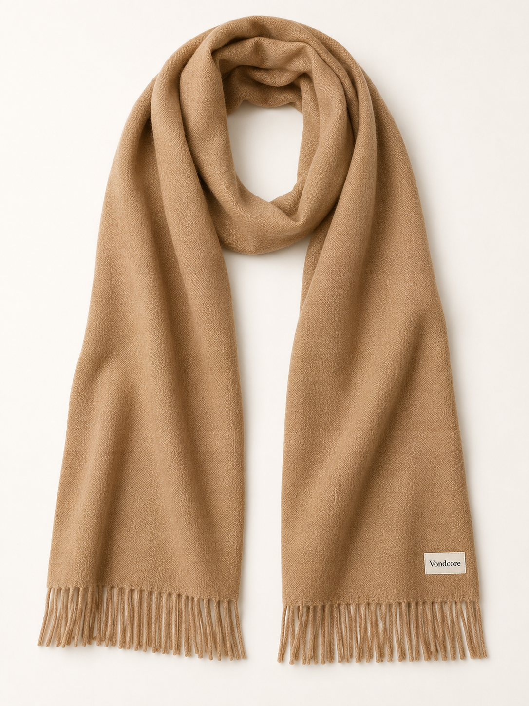 Vondcore Traverse Fringe Scarf in camel, full view showing the woven texture, fringed ends and branded corner label.